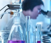 woman looking through a microscope